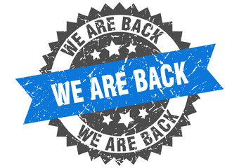 we are back stamp. grunge round sign with ribbon