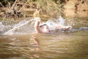 Two boys swimming in the Goulburn River, New South Wales Australia. Holiday photos on Australian road trip.