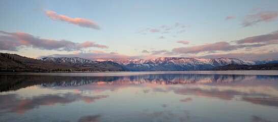 Sunrise over lake Chelan in eastern washington with the snowy cascade mountains in the background. lonely, single desolate area