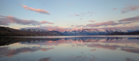 Sunrise over lake Chelan in eastern washington with the snowy cascade mountains in the background....