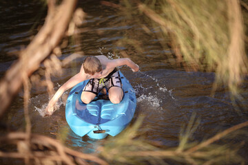 Boy kayaking Goulburn River, New South Wales Australia. Adventure holiday family road trip.