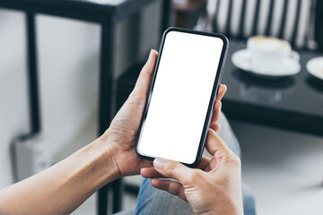 cell phone mockup blank white screen.woman hand holding texting using mobile on desk at coffee shop.background empty space for advertise.work people contact marketing business,technology