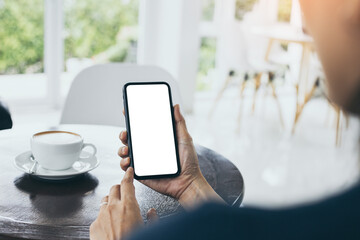 cell phone mockup blank white screen.woman hand holding texting using mobile on desk at coffee shop.background empty space for advertise.work people contact marketing business,technology