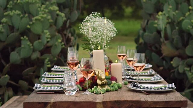 Low angle shot of an outdoor dining table setup and decorated for the holidays at dusk.