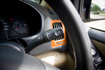 Obraz premium Switch off lights in a car. close-up Car integrated turning indicator with headlight switch toggle.