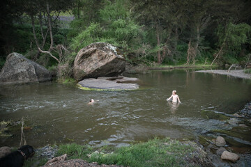 Two boys swimming in the Goulburn River, New South Wales Australia. Holiday photos on Australian road trip.