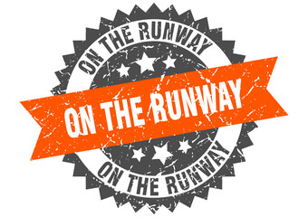 on the runway stamp. grunge round sign with ribbon