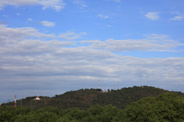 Fototapeta na wymiar 1P7A8255--ss Antenna pole on top of mountain againt with cloudy sky