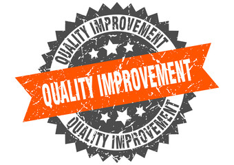 quality improvement stamp. grunge round sign with ribbon