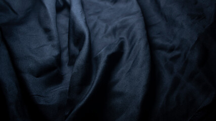 Fototapeta premium The surface of the black cloth with wavy marks