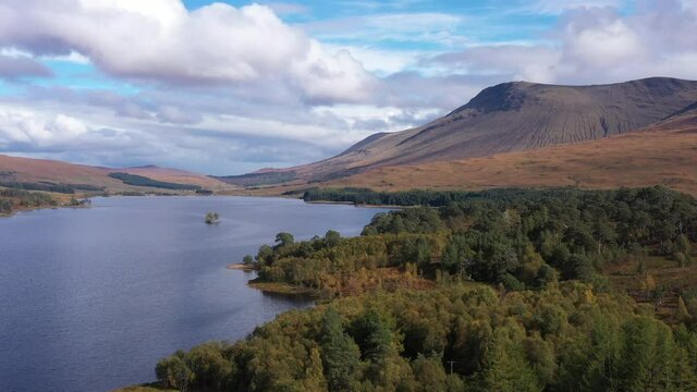 aerial drone image of loch tulla in the argyll region of the highlands of scotland during autumn on a clear bright day showing calm waters on the inland loch