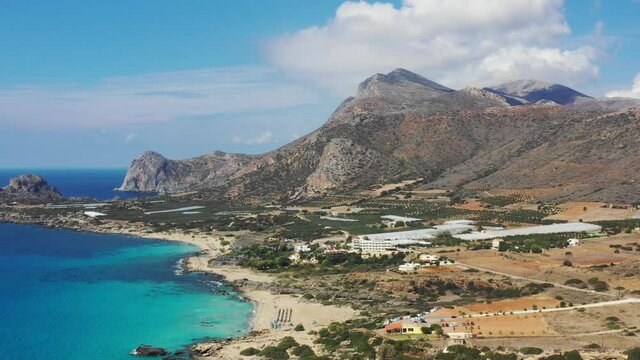 Aerial drone video of Falassarna beach, crystal waters, golden sand, endless sandy turquoise beach of Falassarna in Crete island, Greece. Famous Falasarna (also known as Falassarna or Phalasarna).