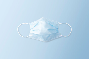 Disposable face mask on the blue color background, Coronavirus (COVID-19) and influenza infection...