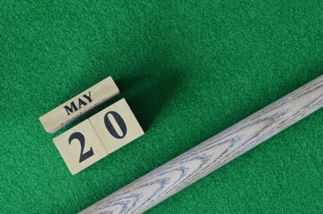 May 20, Number cube With a snooker stick on a green background, snooker table.