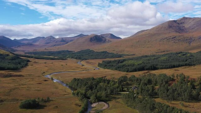 aerial drone image of loch tulla in the argyll region of the highlands of scotland during autumn on a clear bright day showing calm waters on the inland loch
