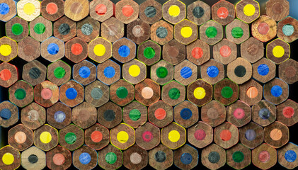 End view of wooden colored pencils. Macro. Close up. Abstract. Background. Texture.