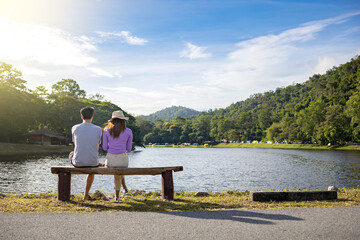 Fototapeta premium Travelers couple look at the mountain lake. Travel happy emotions Lifestyle concept.