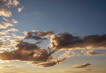 This image shows a blue sky and clouds being illuminated by a golden setting sun.