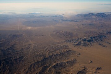 This aerial image capture shows a high up perspective of nature and earth's mountainous land.