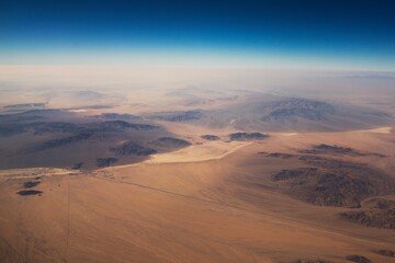 Fototapeta na wymiar This aerial image shows a breathtaking view of vast desert landscape.