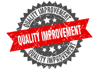 quality improvement stamp. grunge round sign with ribbon