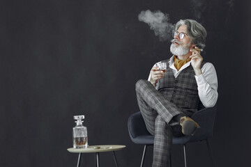 Close up portrait of grinning old-fashioned man. Elegant man in a studio. Grandfather with a cigar...