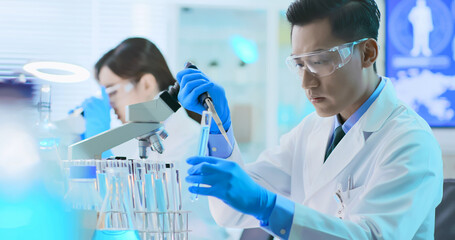 Asian scientist take test tube