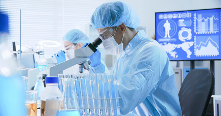 asian scientist use microscope