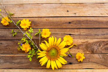 yellow flowers cosmos, marigolds and  sunflowers arrangement flat lay postcard style on background wooden