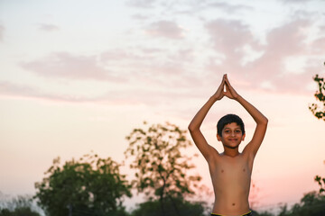 the indian priest child doing meditation