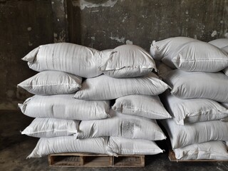 product stock is packed in sacks, stacked in the warehouse, waiting for delivery.	

