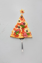 Piece of pizza set like christmas tree.