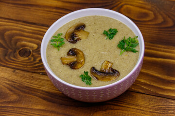 Mushroom cream soup on a wooden table