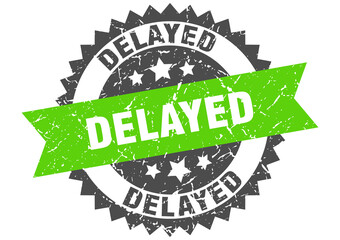 delayed stamp. grunge round sign with ribbon