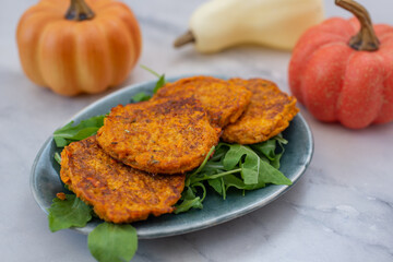 healthy home made pumkin patties with avocado and arugula salad