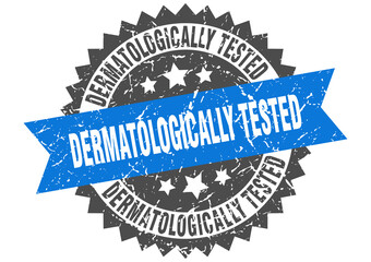 dermatologically tested stamp. grunge round sign with ribbon