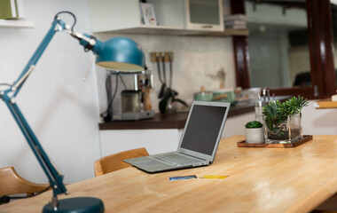 Laptop and credit card on the table at home.