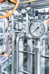 Pressure gauges mounted on the pipeline.