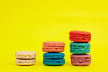French colorful macarons on a yellow background.Dessert, sweets.