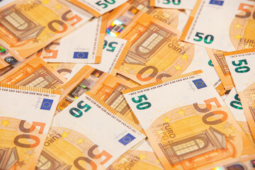Background text of fifty euro banknotes. Selective focus.