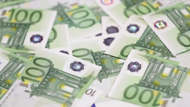 Hundred euro cash bills go round and round. Euro money close up