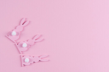 Fototapeta na wymiar Pink Easter bunnies on pink background, easter greeting card, top view with copy space