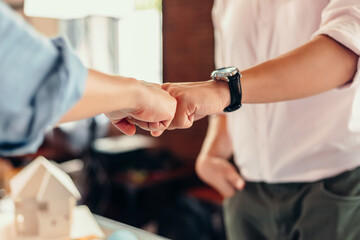 Engineer and architect partners giving fist bump after complete deal.