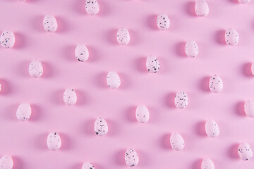 Easter pattern with pink Easter eggs on a pink background, top view