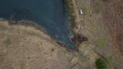 Viewing a dam from a vehicle in a game reserve