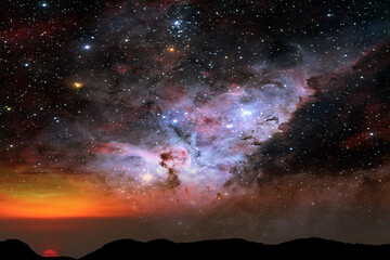 tree on the silhouette mountain and nebula galaxy on the sunset sky