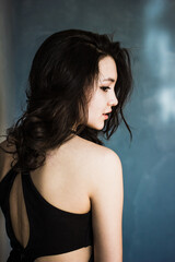 Fototapeta premium Black hair woman. Beautiful brunette hairstyle fashion portrait over dark background