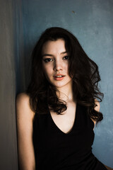 Black hair woman. Beautiful brunette hairstyle fashion portrait over dark background