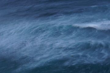 Abstract seascape of stormy blue water with waves