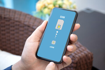 male hand holding phone with Sim card replacement on eSim